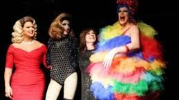 Laura Donorfio alongside three drag queens dressed in elaborate attire